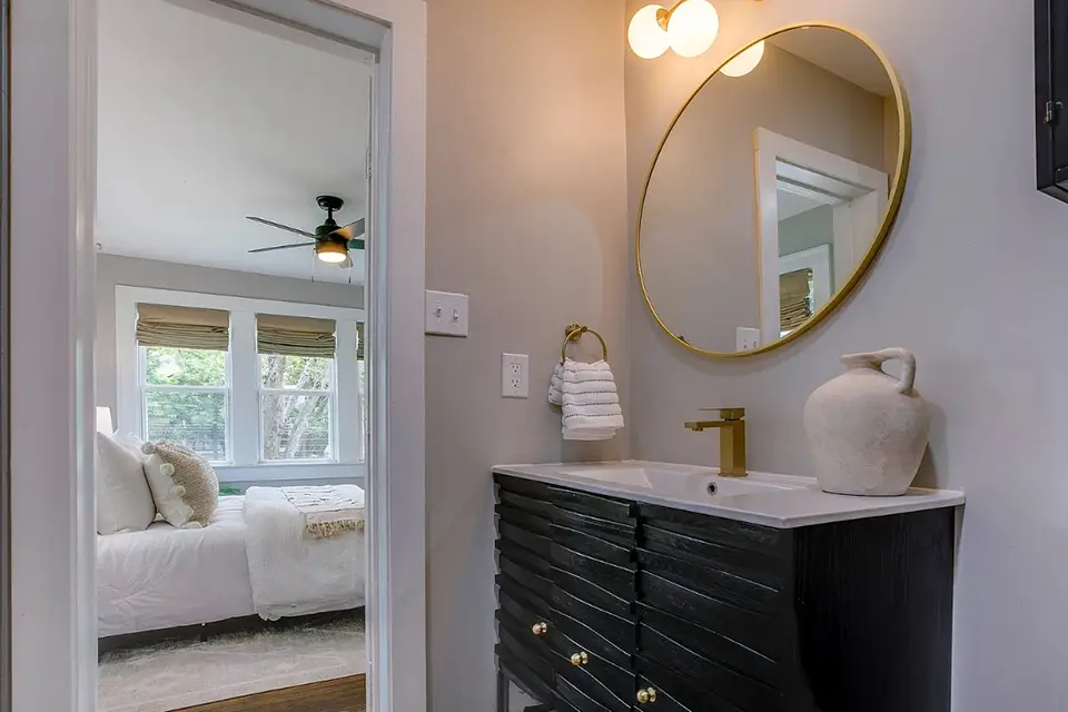 master bathroom with bedroom in background