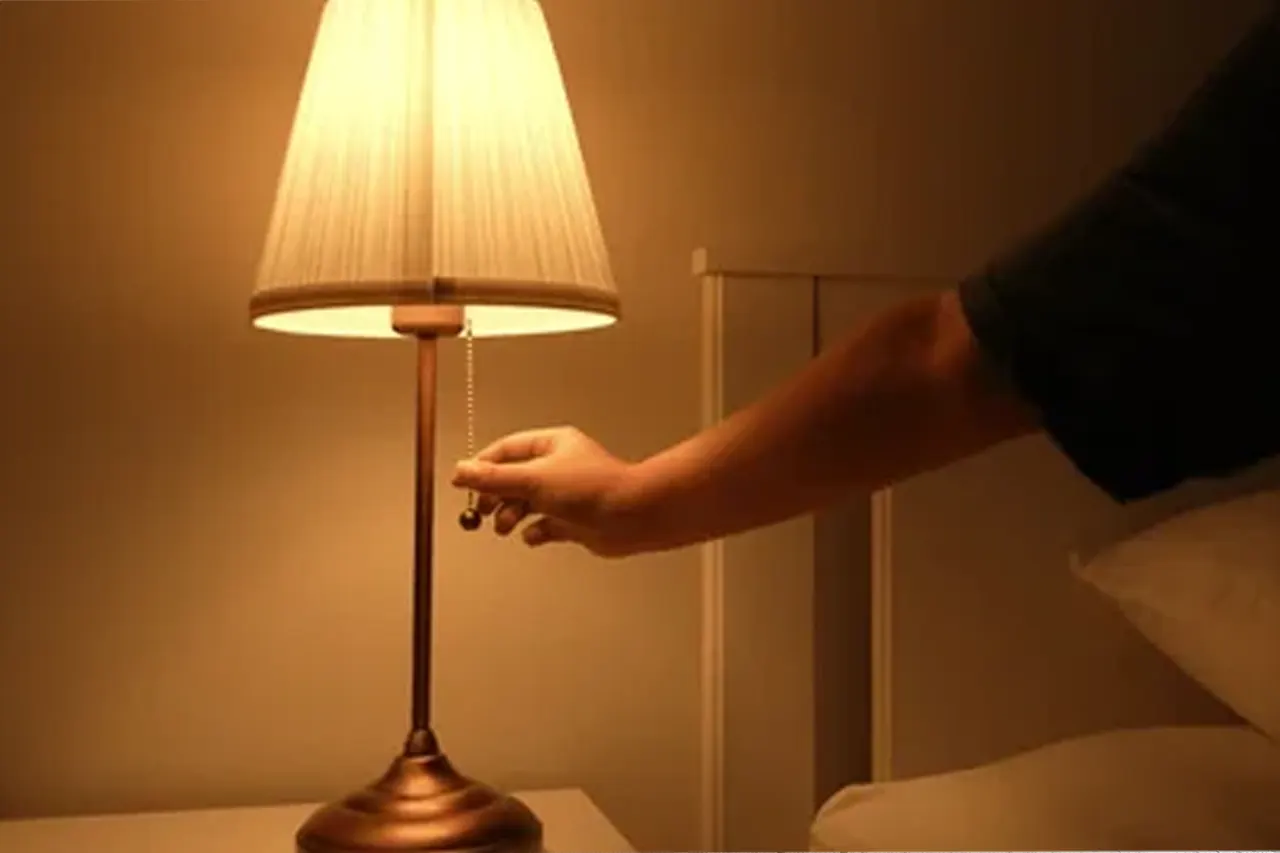 hand switching on lamp